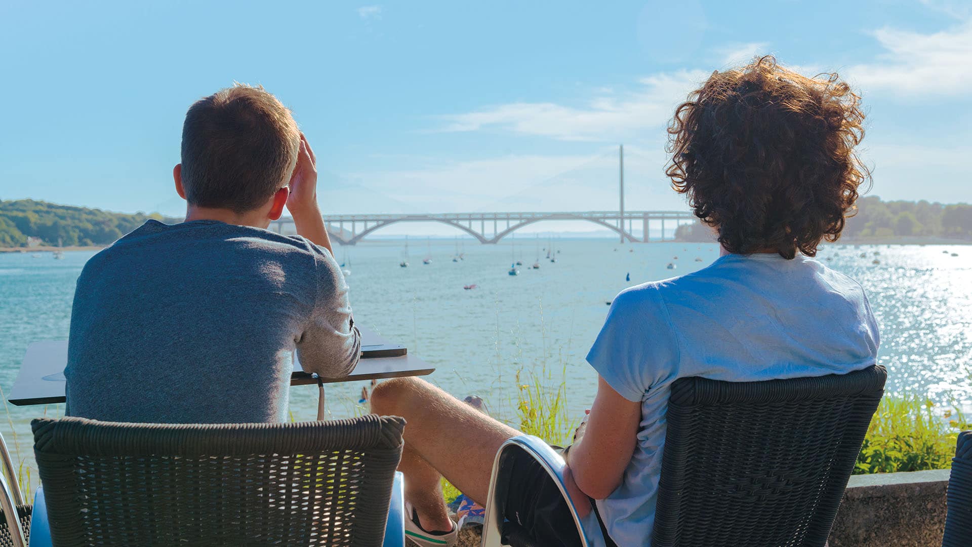 Two people having a drink overlooking Brest harbour